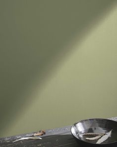 a black bowl sitting on top of a wooden table