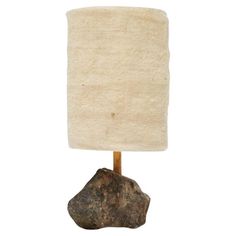 a rock lamp with a white shade on it