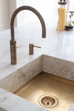 a kitchen sink with a faucet and soap dispenser