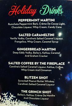 the holiday drinks menu is displayed on a black board