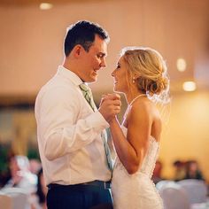 a bride and groom dance together at their wedding reception