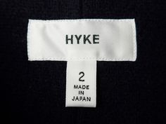 a label on a black sweater that says hyke 2 made in japan,