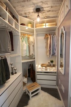 a walk in closet filled with lots of clothes