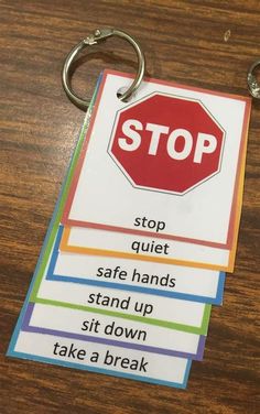 there is a stop sign and some words on the tags that are attached to each other