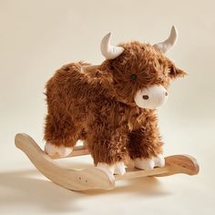 a stuffed cow is sitting on a wooden sled and looks like he's ready to ride