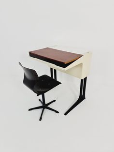 a desk and chair are shown against a white background in this image, there is also a black chair