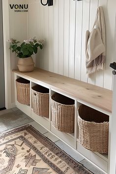 Entryway with a wooden bench featuring built-in cubbies with wicker baskets, a potted plant on the bench, and a scarf hanging on the wall. Storage Bench Entryway Decor, Console Table Hallway With Shoe Storage, Entry Bench And Shoe Storage, No Entry Entryway, Entryway Seating And Storage, Entryway Built In Bench Ideas, Built In Entry Bench With Storage, Foyer Organization Ideas, Diy Wooden Storage Bench