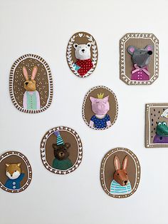 a white refrigerator covered in magnets with animals on it