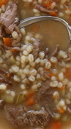 a spoon full of soup with meat and rice