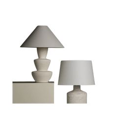 two white lamps sitting next to each other