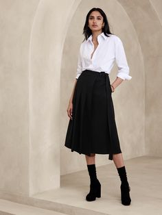 This midi skirt uses a pleated, asymmetrical front to inspire and is cut from a bonded twill fabric we love for its soft structure.  A-line fit.  Adjustable belt at wearer's left.  Side seam pockets.  Unlined.  A-line.  Midi length.  Model: Size 2, 5'10" (178cm). Dark Academia Office Wear, Asymmetrical Skirt With Belt Loops For Work, Asymmetrical Pleated Skirt For Work, Asymmetrical Lined Skirt For Work, Lined Asymmetrical Skirt For Work, Fitted Belted Pleated Skirt For Work, Fall Pleated Skirt With Belt Loops For Work, Fall Workwear Pleated Skirt With Belt Loops, Fitted Midi Wrap Skirt For Work