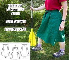 a woman in green skirt and red shirt holding a yellow paddle with the text, sikskyyou adventure skirt ppf pattern size xs xxxl