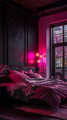 a bed with pink sheets and pillows in a dark room