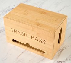 a wooden box with the words trash bags printed on it