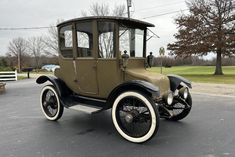 an old car is parked in a parking lot