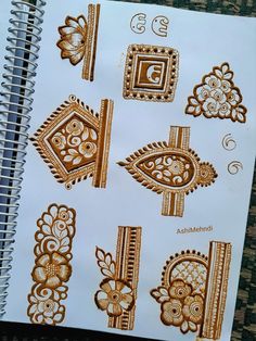 an open notebook with hendi designs on it