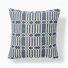 a blue and white pillow on a white background