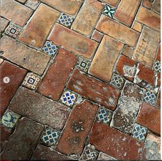 an old brick floor with blue and red tiles