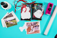 various items are laid out on a blue surface, including two polaroids and one camera