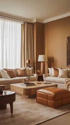 a living room filled with furniture and a large window covered in draping curtains