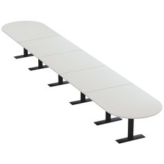 a long white surfboard sitting on top of two black stands next to each other