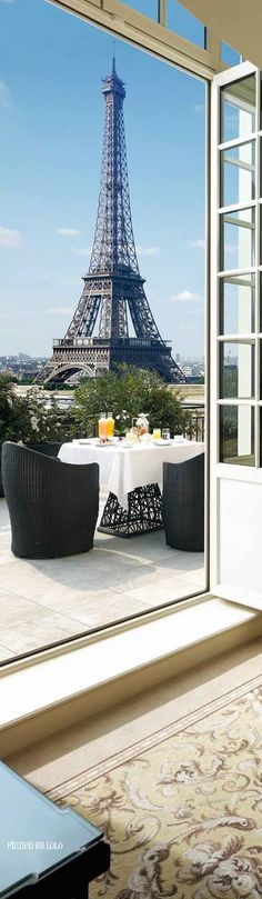 the eiffel tower is seen through an open window