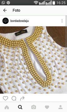 a white shirt with gold beads on the collar and neckline is shown in an instagram