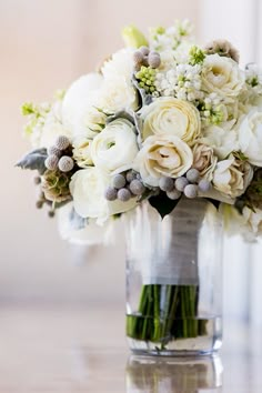 a vase filled with white flowers on top of a table