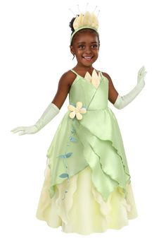 A Bayou Dream
When we watch one a beloved animated movie, we can easily imagine stepping into the world and going on the adventure, too. So, it is only natural that our littlest tykes are even more eager to twirl into the experience. Now we can make that dream even better thanks to our Disney The Princess and the Frog Tiana Costume for Toddlers.
Design & Details
This Made By Us design is inspired by the gown worn by Tiana in the film and is sure to bring a smile to your kiddo's face. It starts with a cascade of light green dupioni with a soft yellow satin skirt layer shining through. The waist is accented with a green vine and yellow organza flower and a dash of elegance is added with a pair of matching spandex gloves and a headband crown.
©Disney Princess Tiana Costume Toddler, Toddler Elsa Costume, Princess Tiana Costume, Disney Princess And The Frog, Tiana Costume, Frog Costume, Matching Halloween Costumes, Snow White Costume, Costume Disney