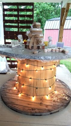 a cake stand with lights on the top