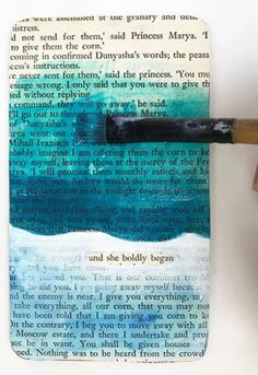 a hand holding a pencil and writing on a piece of paper that has been altered to look like an ocean scene