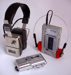 an old fashioned camera and headphones are sitting next to each other