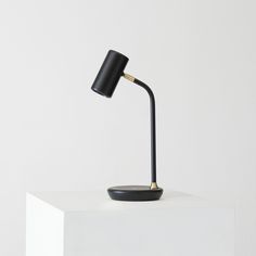 a black lamp sitting on top of a white table