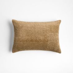 a brown pillow on a white wall