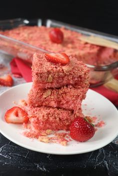 three pieces of cake on a plate with strawberries