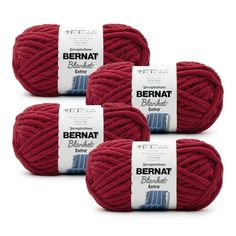 three balls of bernat yarn in red