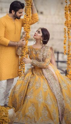 a man and woman dressed in yellow standing next to each other