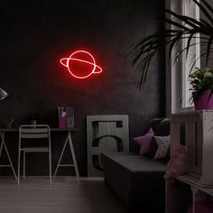 a living room filled with furniture and a neon sign on the wall that says peace