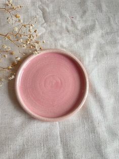 a pink bowl sitting on top of a table