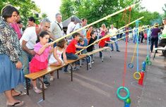 a group of people sitting on top of wooden benches