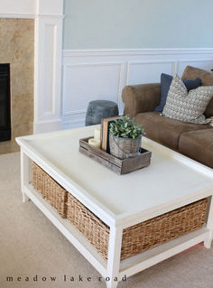 a living room with a couch, coffee table and fireplace in the centerpieces