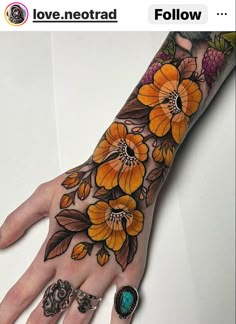 a woman's hand with yellow flowers on it