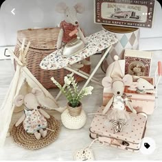 there are many items on the table and in front of them is a basket with an ironing board