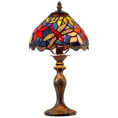 a table lamp with a dragonfly design on the glass and gold base, against a white background