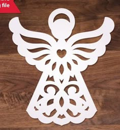 an angel cut out on top of a wooden table