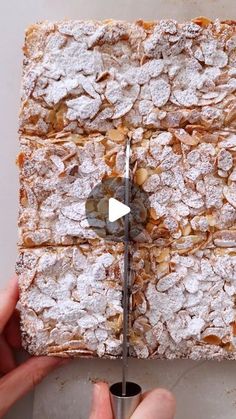 a person cutting into a piece of food with a pair of scissors in front of it