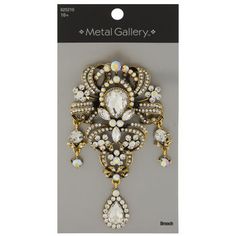 Accessorize for a look that will brighten your day with this Ornate Rhinestone Brooch. This brooch comes in an ornate shape with internal cutouts and wide flourishes around a central gem. The face of it is encrusted with brilliantly clear and pearlescent rhinestones. Pin the brooch to your lapel, jacket, or bag for a shiny accent. Match it with a necklace or bracelet to really show off your style! Details: 	 Dimensions: 2.01" x 1.09" 	 Material: Metal & Crystal 	 Color: Clear & Pearlescent White Vintage Jewelry Antique, Lapel Jacket, Print Coupons, Fabric Bolts, Rhinestone Brooches, Fabric Trim, White Metal, Brighten Your Day, Antique Gold