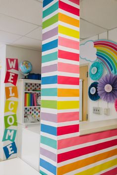 a colorful classroom decorated with paper flowers and rainbow decorations