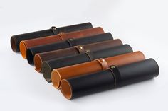 six leather tubes lined up in a row