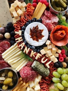 an assortment of cheeses, meats, and vegetables arranged in a circular arrangement